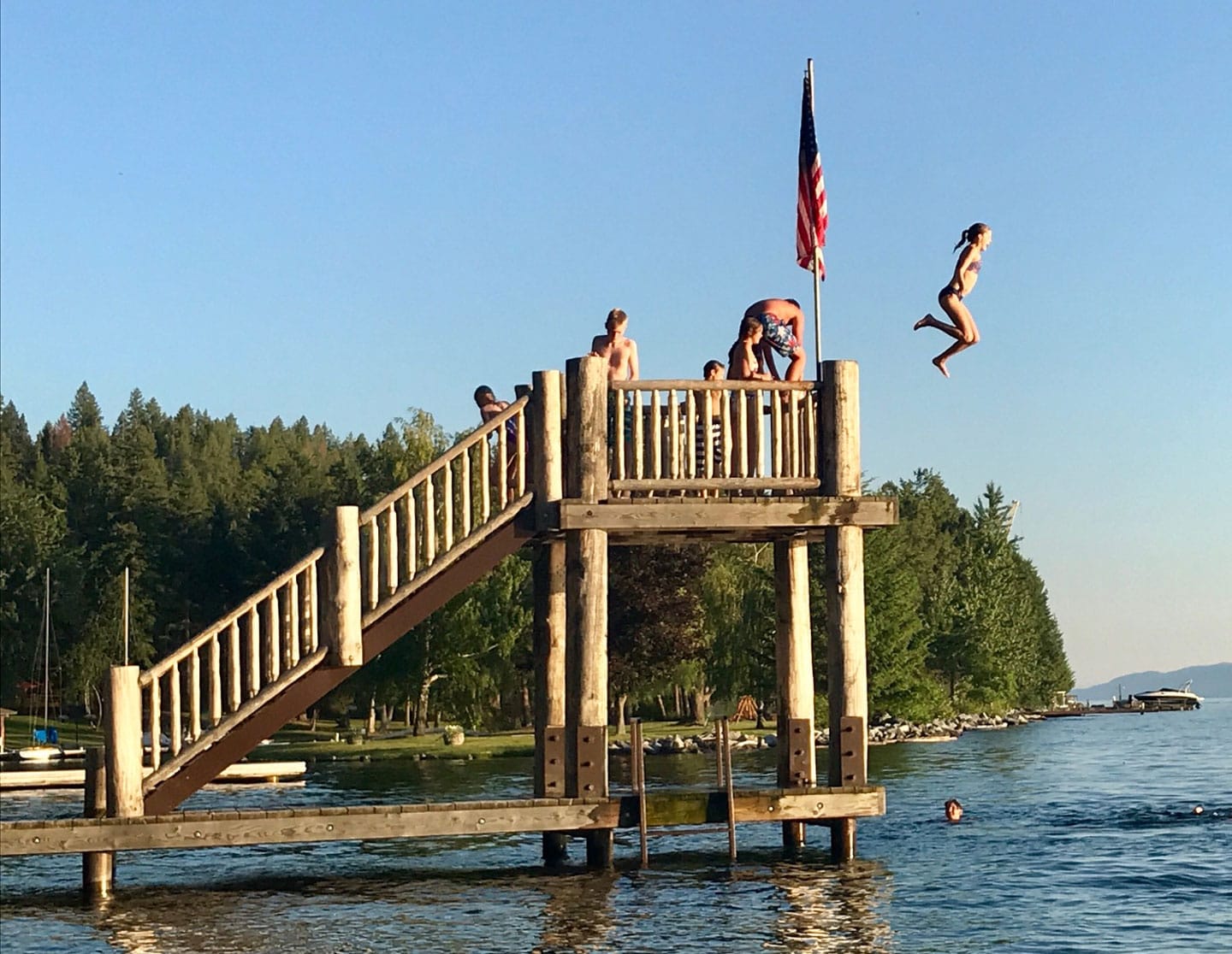 Girl jumping into lake