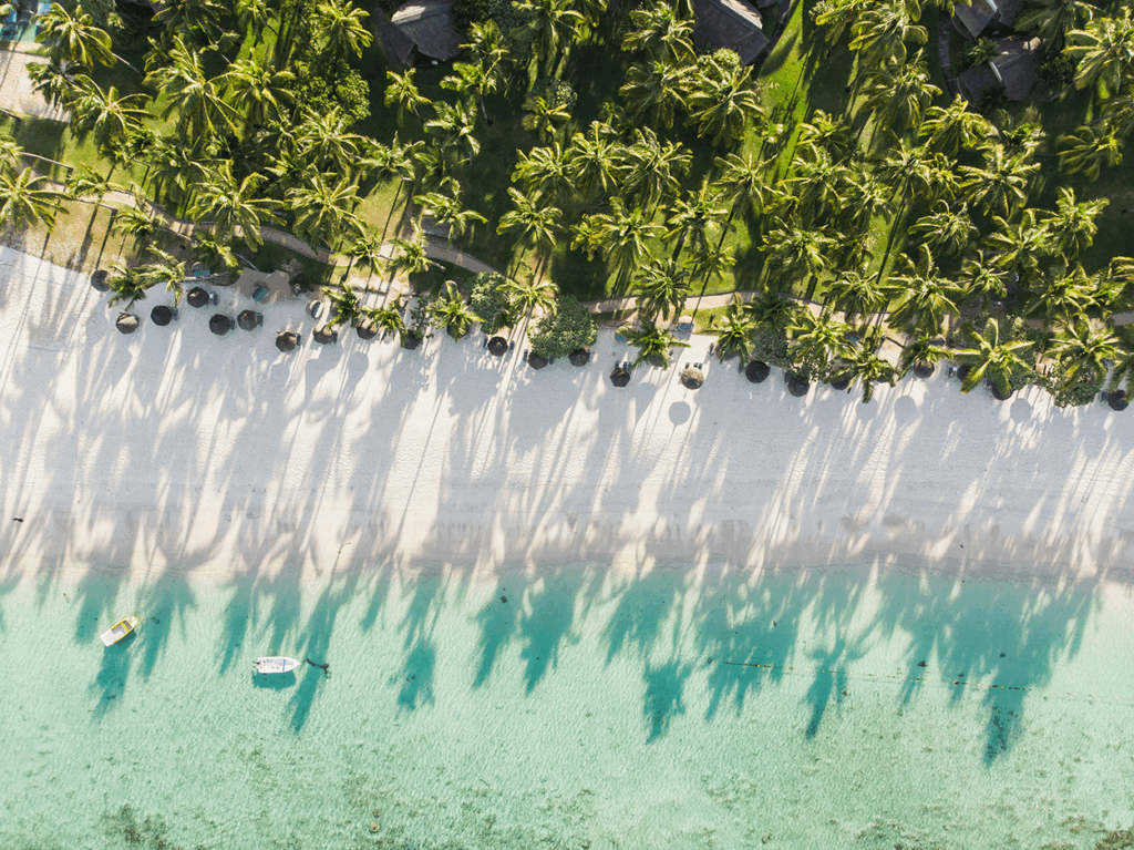 Aerial view of a morning on Flic-en-Flac Beach, Mauritius. Photo by Teodor Kuduschiev/Unsplash